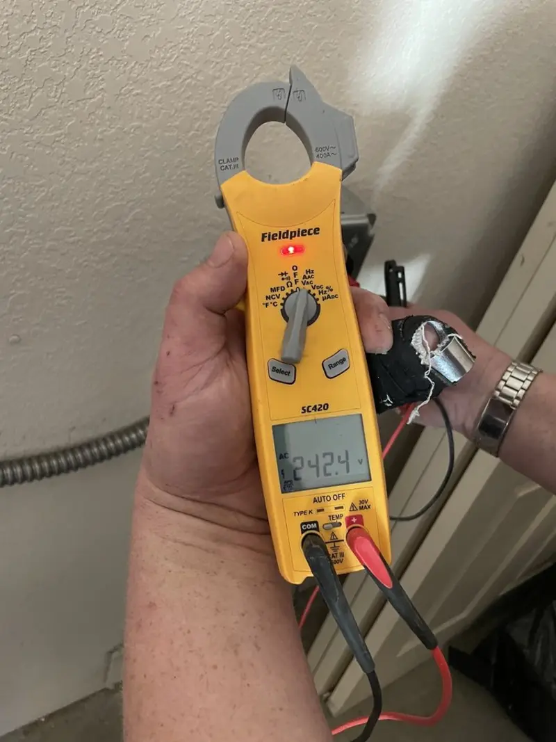 Voltage testing with clamp meter during Outlet Installation in Adams